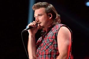 a man in a plaid shirt singing into a microphone morgan wallen wallpaper