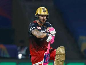 a man in a red and gold batting helmet rcb wallpaper