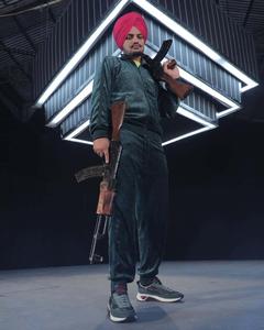 a man in a turban holding a gun Wallpaper
