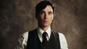 a man in a vest and tie is posing Wallpaper