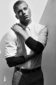 a man in a white shirt and black pants Wallpaper