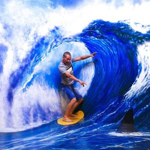 a man is surfing Wallpaper