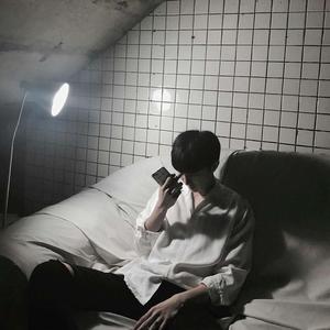 a man sitting on a bed aesthetic boy wallpaper