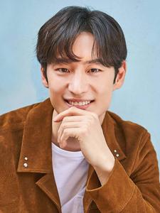 A man stands at the shoreline taking in the beauty of a tropical beach. Wallpaper