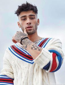 a man with tattoos and a sweater Wallpaper