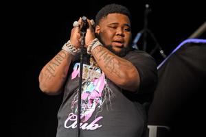 a man with tattoos on his arms is holding a microphone rod wave wallpaper