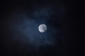 A mesmerizing view of the moon surrounded by a starry night sky. moon wallpaper
