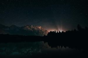 a mountain range with stars and trees in the night dark wallpaper