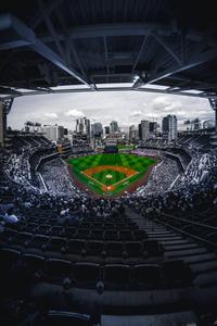 A packed stadium of fans cheer on their team in an exciting Baseball game! baseball wallpaper