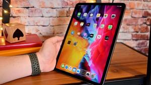 a person holding an apple ipad pro with a screen ipad wallpaper
