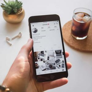 a person holding an iphone with a picture of a coffee cup instagram wallpaper