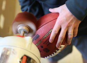a person is holding a football football wallpaper