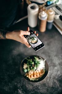 a person taking a photo of a food instagram wallpaper