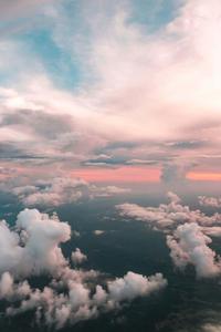 a plane flying over the clouds calming iphone wallpaper