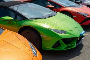 a row of colorful sports cars parked in a parking lot lamborghini wallpaper