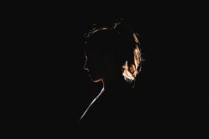 A silhouette of a beautiful Black girl embracing the sunset black wallpaper