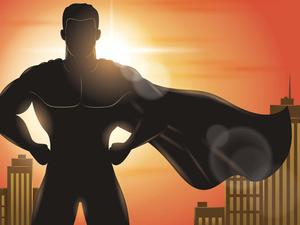a silhouette of a superhero standing in front of a city superhero wallpaper