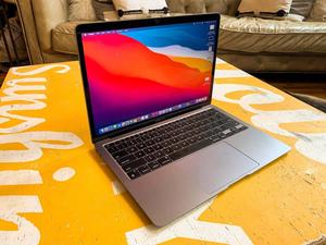 A sleek, modern laptop on a vibrant purple and pink background laptop wallpaper