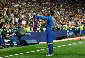 a soccer player is holding up a scarf messi wallpaper
