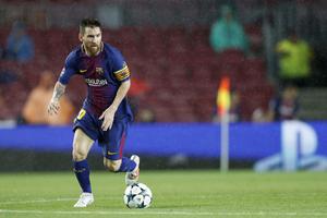 a soccer player is kicking the ball in the rain messi wallpaper
