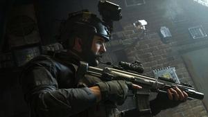 a soldier is holding a gun in a dark room