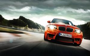 A sporty orange BMW M4 delivers performance and style. car wallpaper
