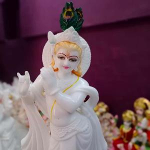 a statue of lord krishna with a feather Wallpaper