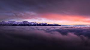 A view of the sky with contrast of vibrant purple and white clouds. 8k wallpaper