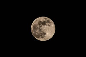 A waning full moon against the backdrop of a starry night sky. moon wallpaper