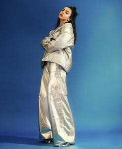 a woman in a silver jacket and pants y2k aesthetic wallpaper