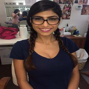 a woman in glasses is smiling in a salon mia khalifa wallpaper