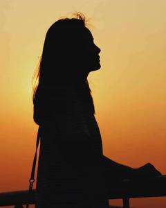 a woman silhouetted against the sunset instagram profile wallpaper