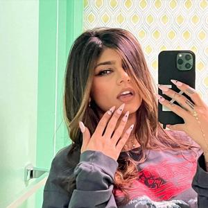 a woman taking a selfie with her phone in a mirror mia khalifa wallpaper
