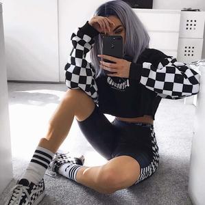 a woman wearing a checkered sweatshirt and sneakers baddie wallpaper