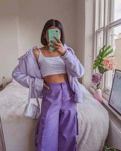 a woman wearing purple pants and a white top aesthetic girl wallpaper