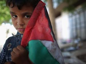 a young boy holding a palestinian flag palestine wallpaper