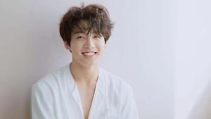 a young man in a white robe smiling jungkook wallpaper