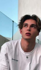 a young man in a white shirt is looking at something aesthetic boy wallpaper