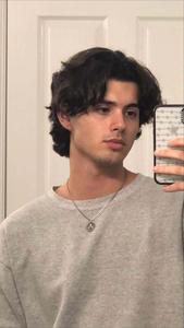 a young man taking a selfie in a mirror aesthetic boy wallpaper