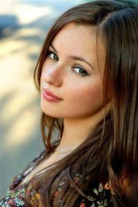 a young woman with long brown hair posing for a photo girl wallpaper