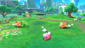 An adorable Kirby character sits on a pile of colorful stars kirby wallpaper