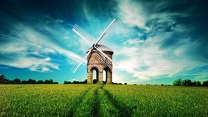 An aerial view of a windmill against a grass-filled landscape 1080p wallpaper