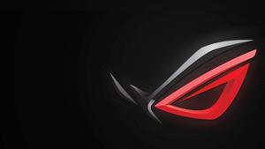 An Asus ROG gaming laptop, featuring an illuminated red eye logo asus wallpaper