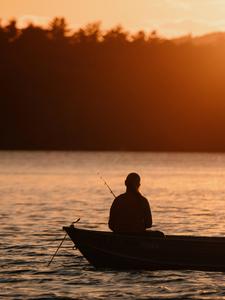 An early morning angler enjoying the tranquility of a tranquil fishing boat. fishing wallpaper