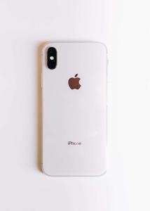 an iphone xr on a white surface Wallpaper