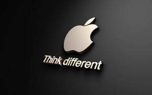 An up close shot of an Apple Logo with a glossy finish. Wallpaper