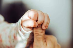 Baby Boy Holding A Thumb baby boy wallpaper