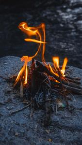 Blazing Campfire On Stone Phone Background phone wallpaper