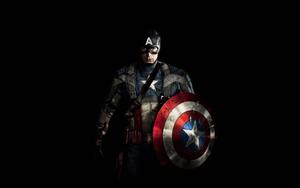 Captain America stands tall and proud in the dark night. captain america wallpaper