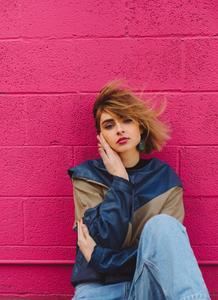 Edgy Cool Girl Leaning Against Graffiti Wall cool wallpaper